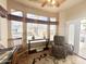 Sunny living area featuring many windows, comfortable chair, and tile floors at 591 S Ironstone Dr, Apache Junction, AZ 85119