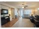 Spacious living room features hardwood floors, a ceiling fan, neutral colors, and plenty of natural light at 591 S Ironstone Dr, Apache Junction, AZ 85119