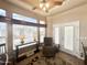 Bright living room with many windows, a ceiling fan, comfortable chair, and tile floors at 591 S Ironstone Dr, Apache Junction, AZ 85119