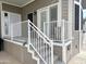 Close up of entry featuring a white railing, steps to the front door, and adjacent desert landscaping at 591 S Ironstone Dr, Apache Junction, AZ 85119