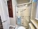 The shower features sliding glass doors and white tiling with built-in bench at 591 S Ironstone Dr, Apache Junction, AZ 85119