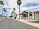 Street view of manufactured homes, with palm trees, showing well-maintained community at 591 S Ironstone Dr, Apache Junction, AZ 85119