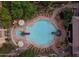 Aerial view of pool with tanning chairs, umbrellas and landscaping at 6900 E Princess Dr # 1176, Phoenix, AZ 85054