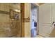 Tiled bathroom featuring a glass enclosed shower stall and neutral colored wall, creating a private space at 6900 E Princess Dr # 1176, Phoenix, AZ 85054