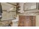 Elegant bathroom featuring a vintage vanity, decorative tile, and a glass-enclosed shower for a luxurious bathing experience at 6900 E Princess Dr # 1176, Phoenix, AZ 85054
