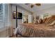 Comfortable bedroom featuring a four-poster bed, ceiling fan, and a large TV at 6900 E Princess Dr # 1176, Phoenix, AZ 85054