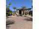 The attractive clubhouse entrance has a fountain and lush landscaping at 6900 E Princess Dr # 1176, Phoenix, AZ 85054
