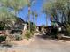 Community entrance featuring desert landscaping, palm trees, and attractive brick paving at 6900 E Princess Dr # 1176, Phoenix, AZ 85054
