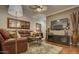 Cozy living room with stylish decor, including a leather sofa, area rug, and entertainment center for comfortable living at 6900 E Princess Dr # 1176, Phoenix, AZ 85054
