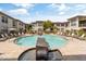Community pool and spa with ample lounge seating and umbrellas at 6900 E Princess Dr # 1176, Phoenix, AZ 85054