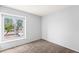 A bedroom with carpet flooring and large windows that provide natural light at 8125 N 32Nd Dr, Phoenix, AZ 85051