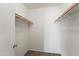 A walk-in closet features white painted brick walls and wood shelves for storage at 8125 N 32Nd Dr, Phoenix, AZ 85051