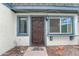 Inviting front door with blue trim, and exterior lighting for curb appeal at 8125 N 32Nd Dr, Phoenix, AZ 85051