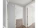 Neutral hallway featuring a neutral paint color and carpeted floors leading to other rooms at 8125 N 32Nd Dr, Phoenix, AZ 85051