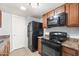 This kitchen features an electric range, overhead microwave, stone counters and wood cabinets at 8125 N 32Nd Dr, Phoenix, AZ 85051