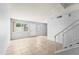 Bright living area with neutral paint, tile floors, and staircase access at 8125 N 32Nd Dr, Phoenix, AZ 85051