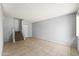 Bright living area with neutral paint, tile floors, and staircase access at 8125 N 32Nd Dr, Phoenix, AZ 85051