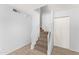 A stairway leads to the next level, featuring carpeted steps and white painted handrails at 8125 N 32Nd Dr, Phoenix, AZ 85051