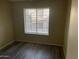 Bedroom with a large window providing plenty of natural light and hardwood flooring at 818 S Westwood -- # 233, Mesa, AZ 85210