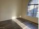 Bedroom with a large window providing plenty of natural light and hardwood flooring at 818 S Westwood -- # 233, Mesa, AZ 85210