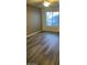 Bedroom with a ceiling fan, hardwood flooring, and a large window providing natural light at 818 S Westwood -- # 233, Mesa, AZ 85210