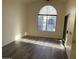 Living room featuring hardwood floors, a large arched window, and a sliding glass door at 818 S Westwood -- # 233, Mesa, AZ 85210