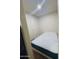 Compact bedroom with a simple bed and neutral walls at 8742 W Edgemont Ave, Phoenix, AZ 85037