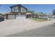 Two-story home with a three-car garage, a walkway, a palm tree, and a lawn in a residential neighborhood at 8742 W Edgemont Ave, Phoenix, AZ 85037