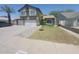 Charming two-story home with a three-car garage, a walkway, a palm tree, and a lawn at 8742 W Edgemont Ave, Phoenix, AZ 85037