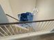 View of a staircase leading to a living room area with an elegant pendant light at 8742 W Edgemont Ave, Phoenix, AZ 85037
