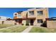 A charming townhome featuring a stucco exterior, small balconies, and well-maintained landscaping at 948 S Alma School Rd # 71, Mesa, AZ 85210