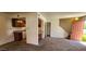 Bright living space with neutral carpet, and light brick accent walls adjacent to the kitchen at 948 S Alma School Rd # 71, Mesa, AZ 85210