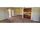 A sunlit room with neutral carpet adjacent to a patio with light entering through the glass doors at 948 S Alma School Rd # 71, Mesa, AZ 85210