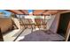 Covered patio with block wall and black metal gate for privacy, and door leading inside at 948 S Alma School Rd # 71, Mesa, AZ 85210