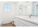 Bathroom with white cabinets, large mirror, and hardwood floors at 10241 E Ursula Ave, Mesa, AZ 85212