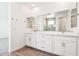 This bright bathroom features double sinks, vanity, and wall-mounted accessories at 10241 E Ursula Ave, Mesa, AZ 85212