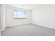 A light bedroom features a bright window and neutral carpet and walls at 10241 E Ursula Ave, Mesa, AZ 85212