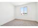 Bright bedroom features a window and neutral carpet at 10241 E Ursula Ave, Mesa, AZ 85212