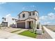 Beautiful two-story home featuring a front yard with brick pavers, fresh grass, and modern design elements at 10241 E Ursula Ave, Mesa, AZ 85212