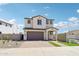 Inviting two-story home featuring a landscaped front yard and a brick paved driveway at 10241 E Ursula Ave, Mesa, AZ 85212