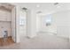 Open hallway featuring a laundry closet, light walls, neutral carpet and natural light at 10241 E Ursula Ave, Mesa, AZ 85212