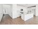 A clean, open-concept kitchen with white cabinetry, island and stainless steel appliances at 10241 E Ursula Ave, Mesa, AZ 85212