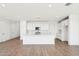 Well-lit, open concept kitchen with an island, white cabinets, and wood-look floors at 10241 E Ursula Ave, Mesa, AZ 85212