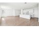 Bright, open-concept kitchen with white cabinetry, a center island, and light wood-look floors at 10241 E Ursula Ave, Mesa, AZ 85212
