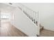 Bright and airy staircase featuring modern white railings and a combination of carpeted and wood flooring at 10241 E Ursula Ave, Mesa, AZ 85212