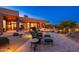Expansive backyard with stone patio, manicured desert landscaping, and serene lounge areas at 10267 E Cinder Cone Trl, Scottsdale, AZ 85262