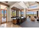 The bar area features stylish seating, a dark countertop, and a large window showcasing the scenic outdoor landscape at 10267 E Cinder Cone Trl, Scottsdale, AZ 85262
