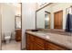 Bathroom featuring double sinks, granite countertop, and an attached toilet room at 10267 E Cinder Cone Trl, Scottsdale, AZ 85262