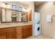 Bathroom showcasing double sinks, a large mirror, and a washer/dryer at 10267 E Cinder Cone Trl, Scottsdale, AZ 85262