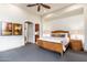 Bedroom features soft carpet and a king bed, with a doorway leading to the kitchen area at 10267 E Cinder Cone Trl, Scottsdale, AZ 85262
